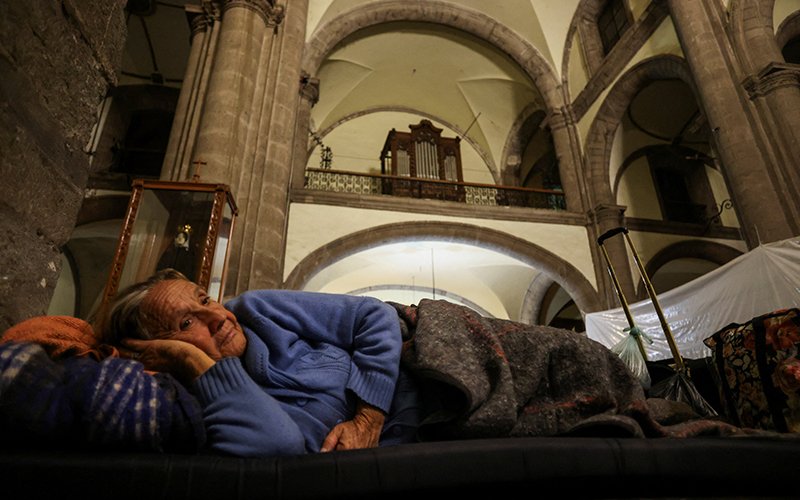 An elderly migrant woman from Venezuela rests as she shelters for the night at Our Lady of the Solitude Church in Mexico City Nov. 27, 2023, as she and other migrants wait for an appointment to be set up with U.S. Customs and Border Protection through the agency's CBP One smartphone app.